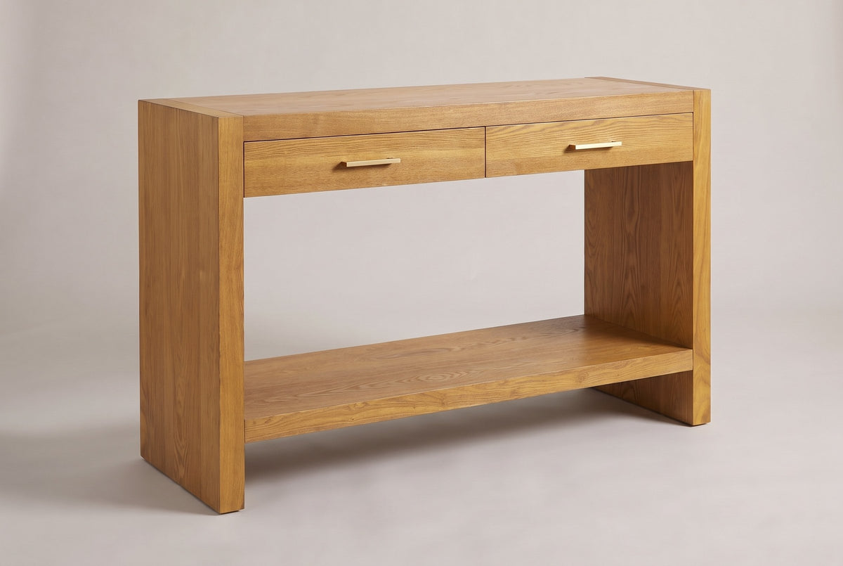 Sibari 2-drawer console table in the Natural honey wood-grain finish, three-quarter view on a warm grey studio backdrop