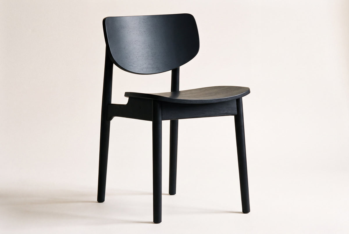 Simone black wood dining chair on an off-white studio backdrop