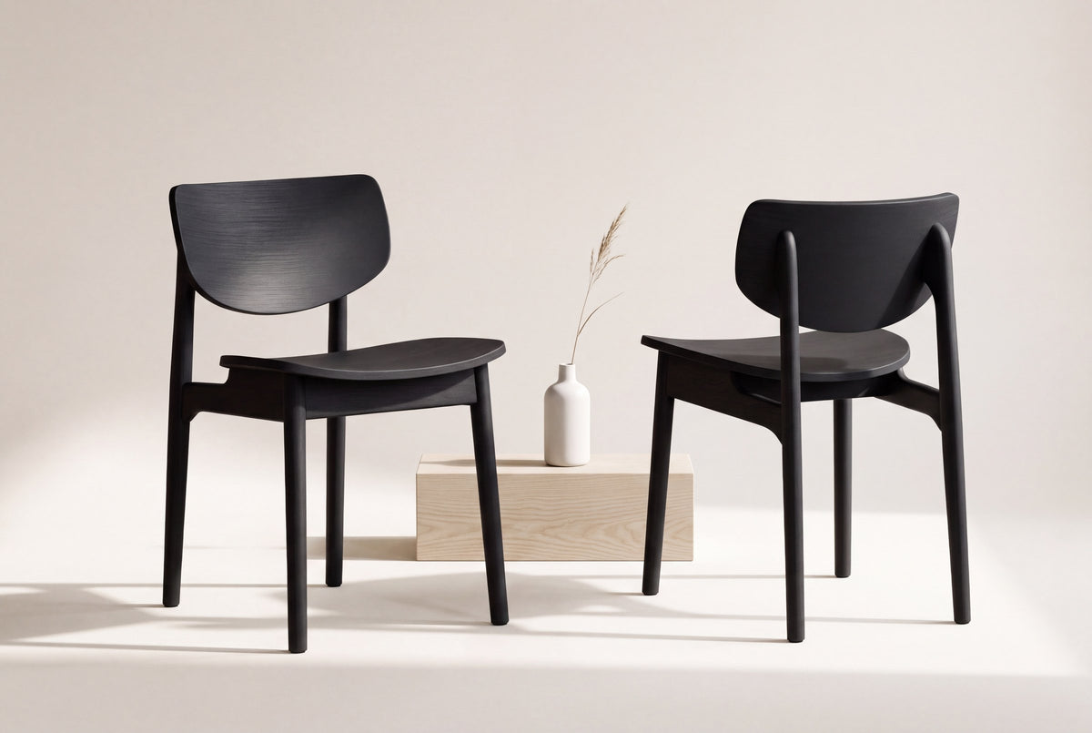 Two Simone dining chairs in black, front and back views, beside a pale ash block