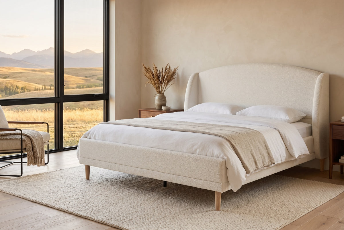 Sirmione boucle wingback bed in a bedroom with a wide window over the foothills at golden hour