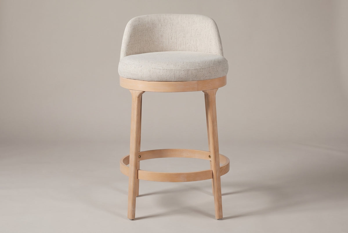 Sirolo counter stool, straight front view showing the round seat, the low wrap-around back, four legs and the footrest ring