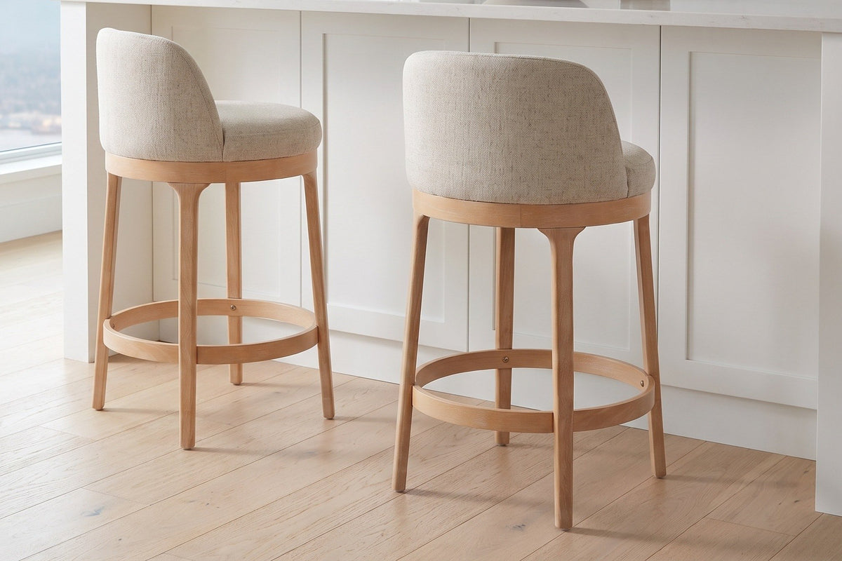 Two Sirolo counter stools pulled out from a white shaker island with a quartz top on a pale oak floor in a Vancouver kitchen