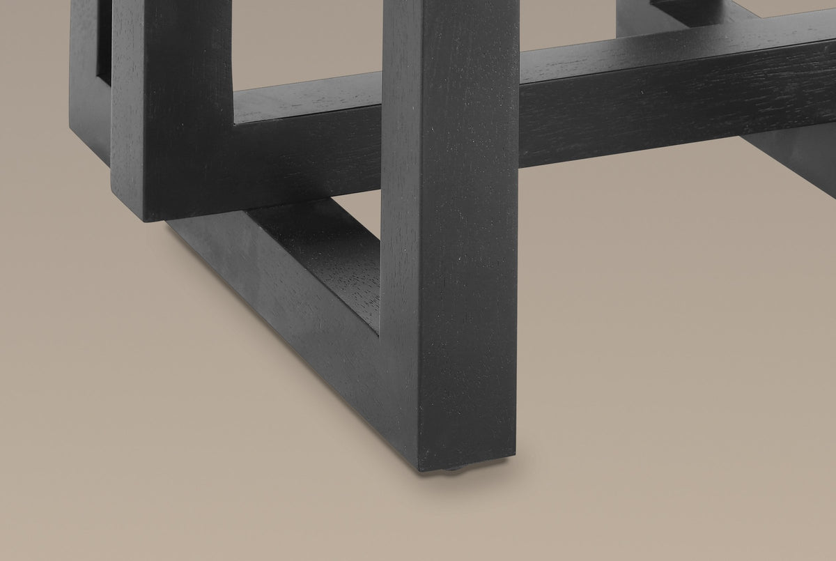 Close-up of the base in black: the lower corner of a hanging frame floating above the bottom rail of a standing frame