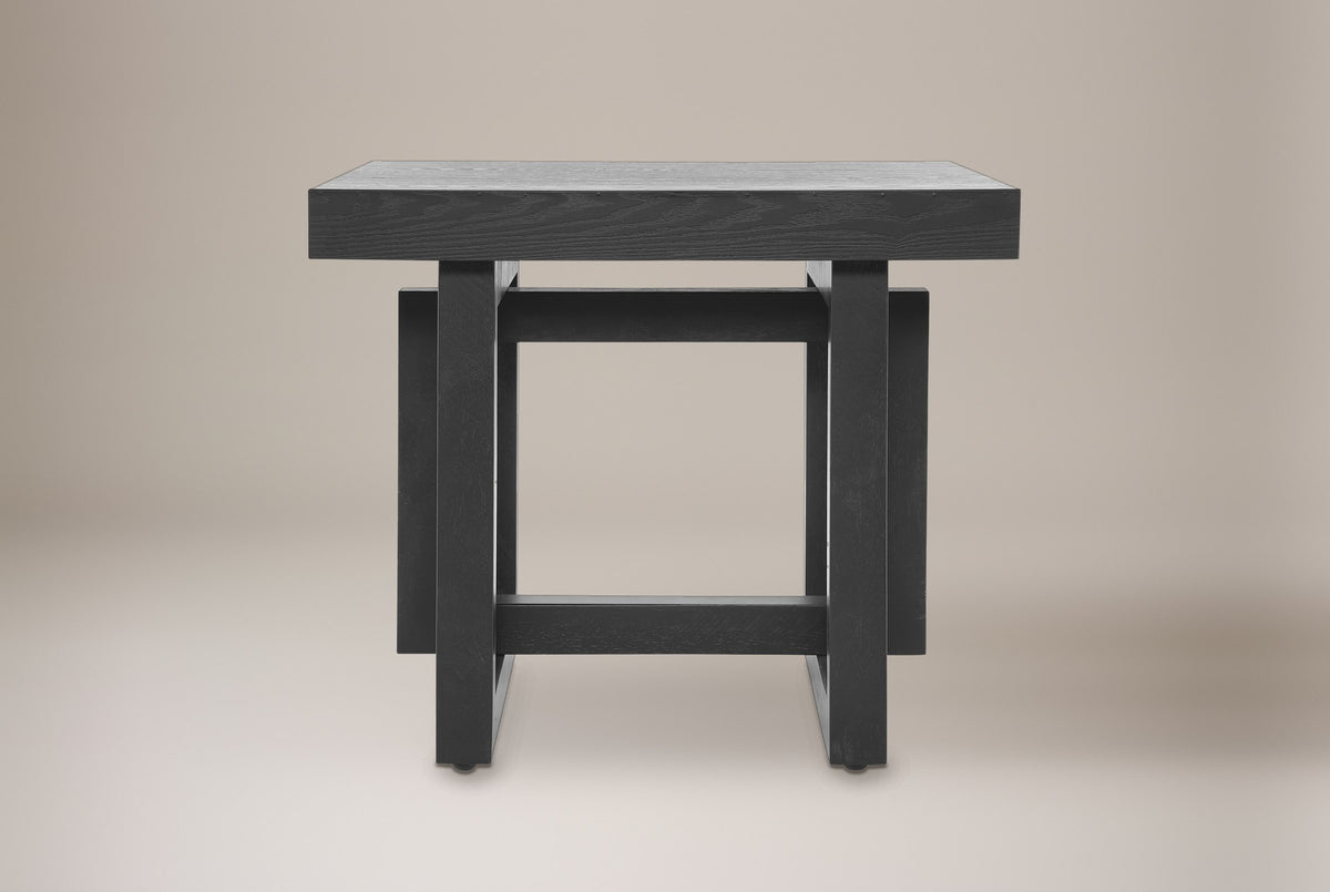 Soave side table in black, straight front view: thick square top, two posts, an upper and a lower rail
