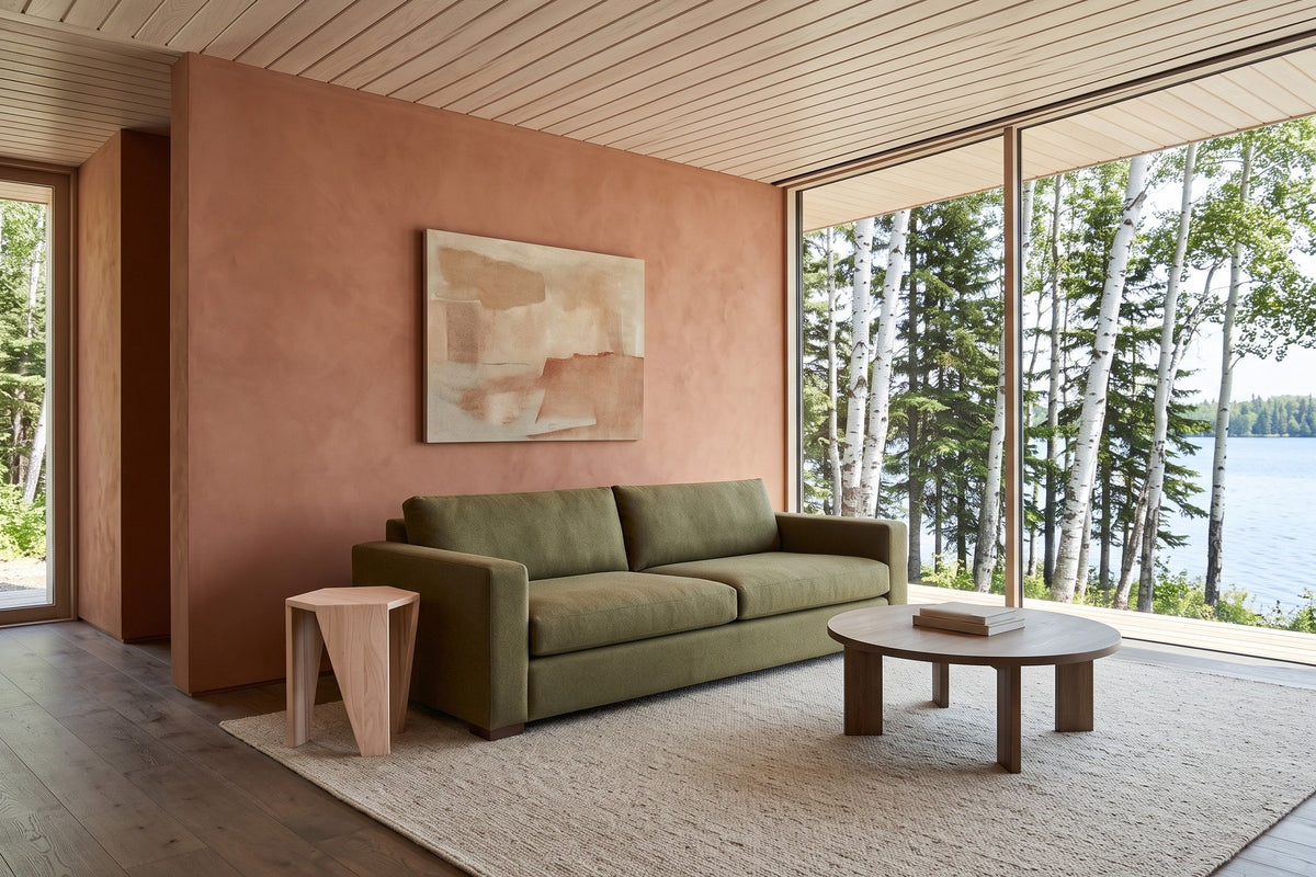 Sovana side table in Sandblast White Elm at the arm of an olive wool sofa in an Emma Lake house