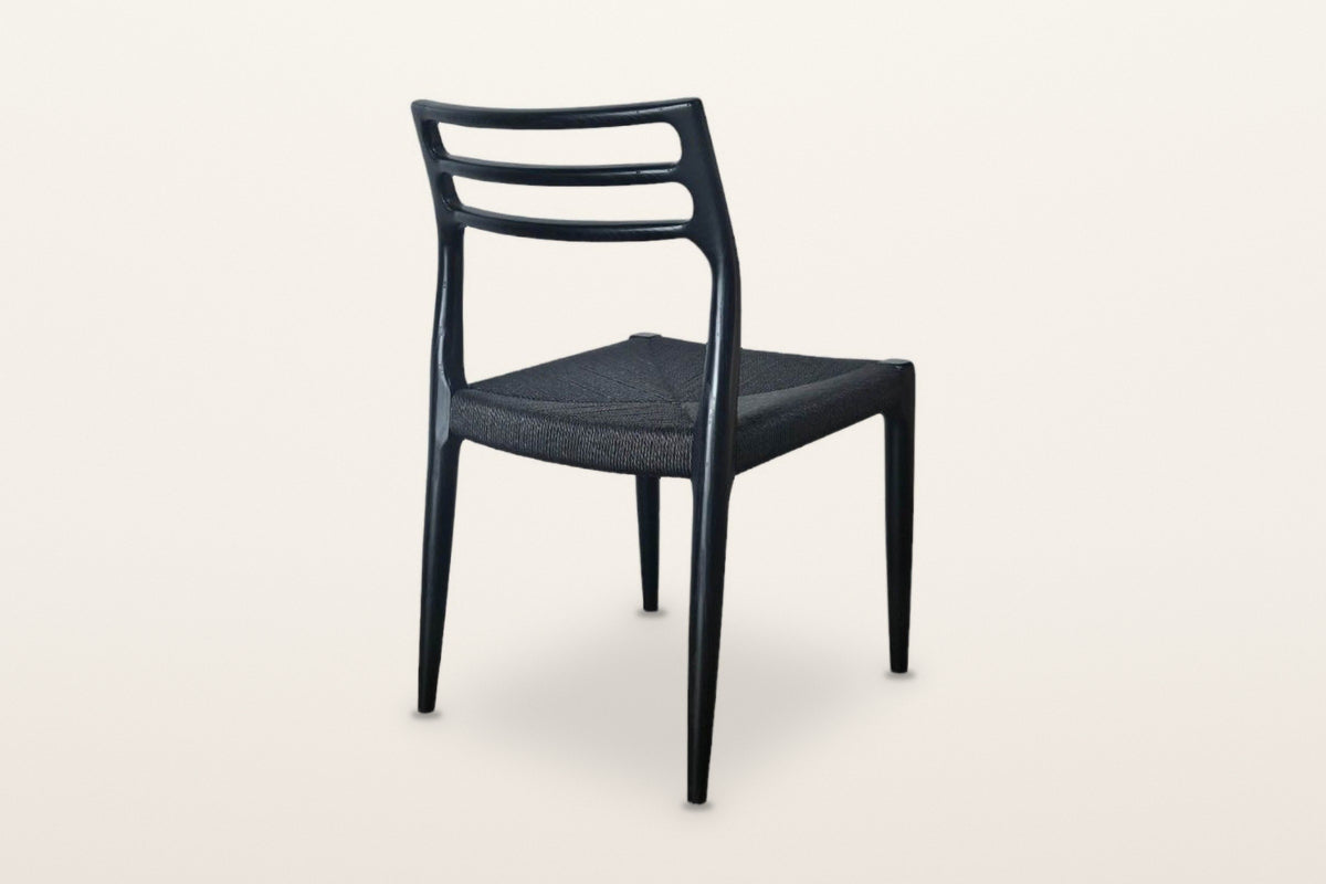 The back of the Sperlinga dining chair in black on a warm white studio backdrop: three rails