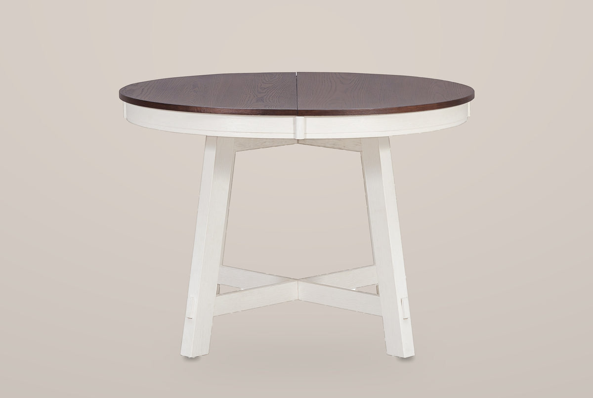 Spilamberto round table, front view: a dark espresso veneer top with a centre seam on an antique-white apron
