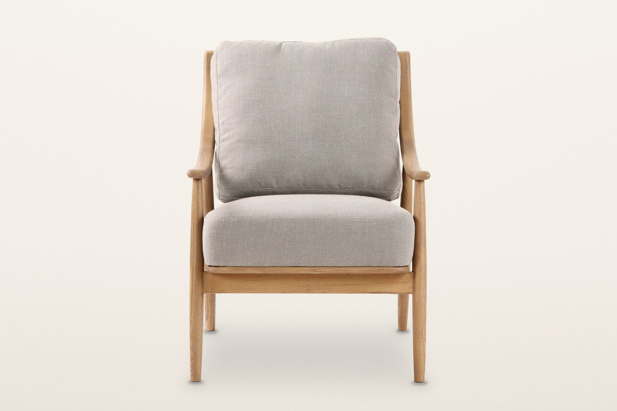 Tagliacozzo accent chair, straight front view on a warm white studio backdrop: arm posts