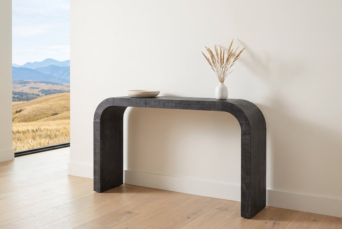 Tarvisio console table in the bright entry of a Calgary foothills house, a wooden bowl and dried grasses on top