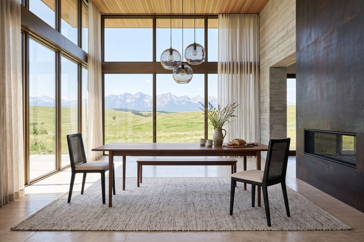Teggiano dining chairs in Black at the two ends of a walnut table in a Cochrane ranch house