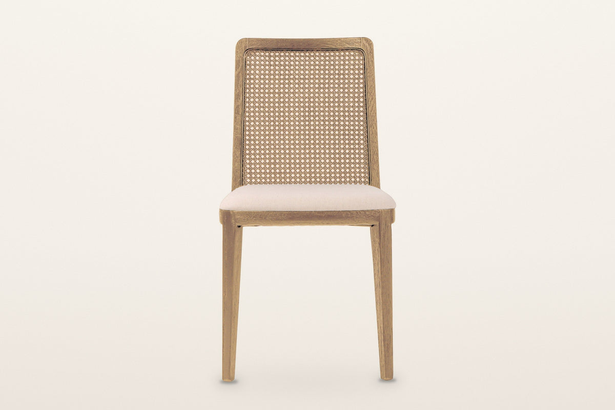 Teggiano dining chair in Natural, straight front view on a warm white studio backdrop