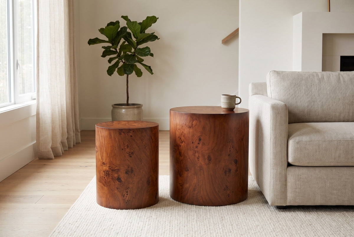 Tirano drum side tables beside an oatmeal linen sofa in a bright Vancouver living room, a stoneware cup on the larger drum