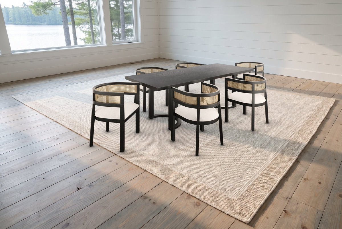 The Tolmezzo dining set on a jute-and-wool rug in a white shiplap Muskoka cottage dining room with a view of the lake