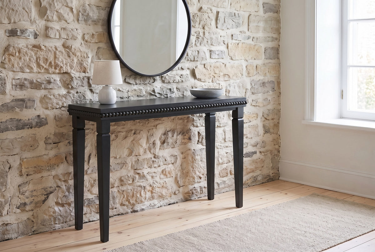 Treviso console table in Black against an old limestone wall in a Quebec City front hall