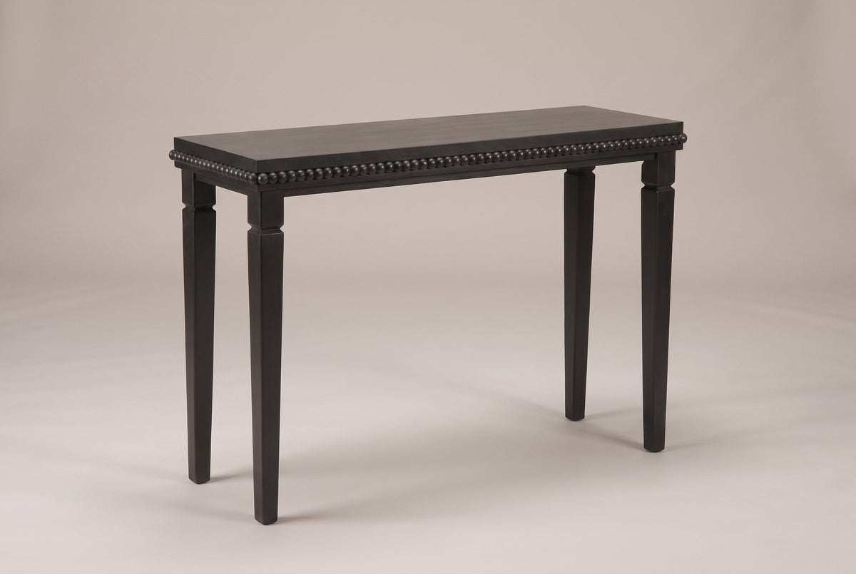 Treviso console table in Black, three-quarter view on a warm grey studio backdrop