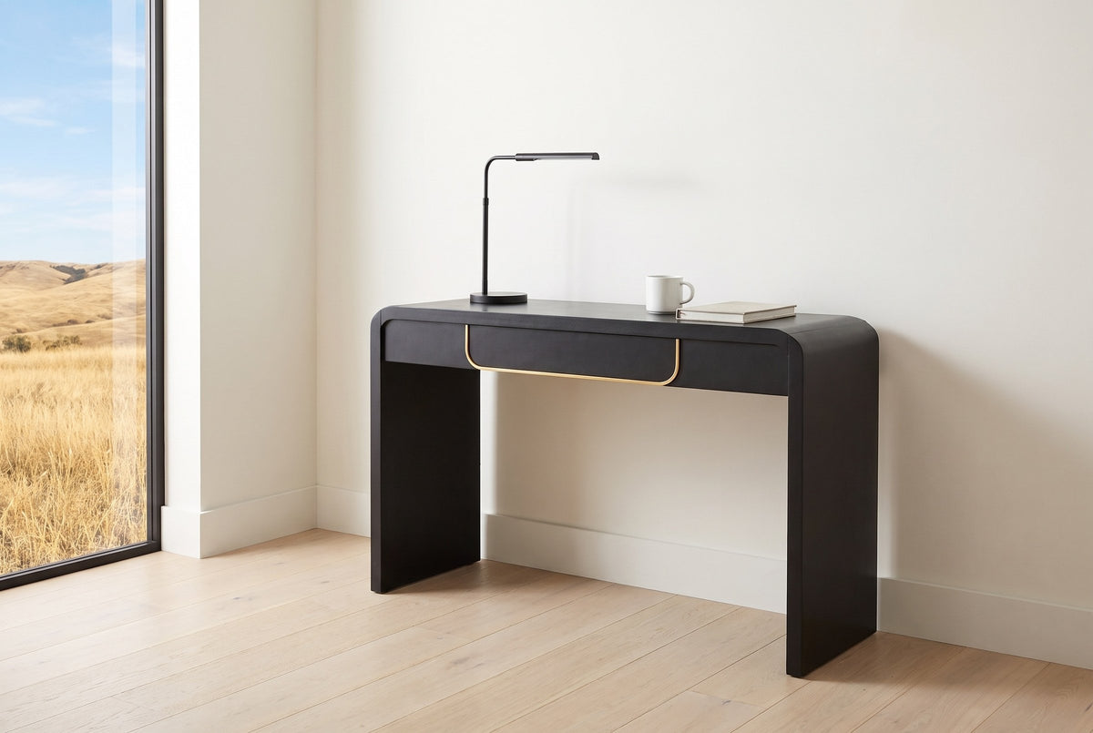 Trieste console table used as a slim desk in a Calgary study nook, a black desk lamp, a mug and a notebook