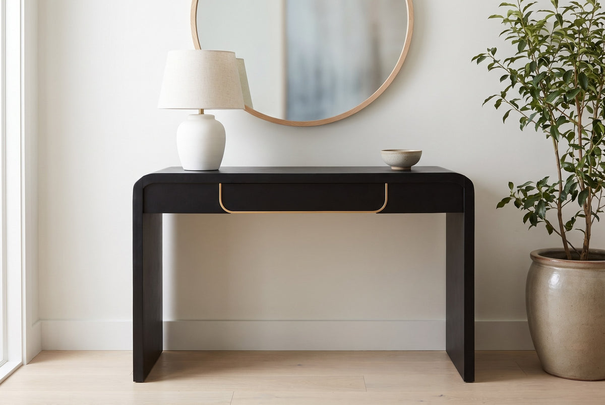 Trieste console table in a bright Vancouver entry, a white ceramic lamp and a stoneware bowl on top, a round oak mirror above