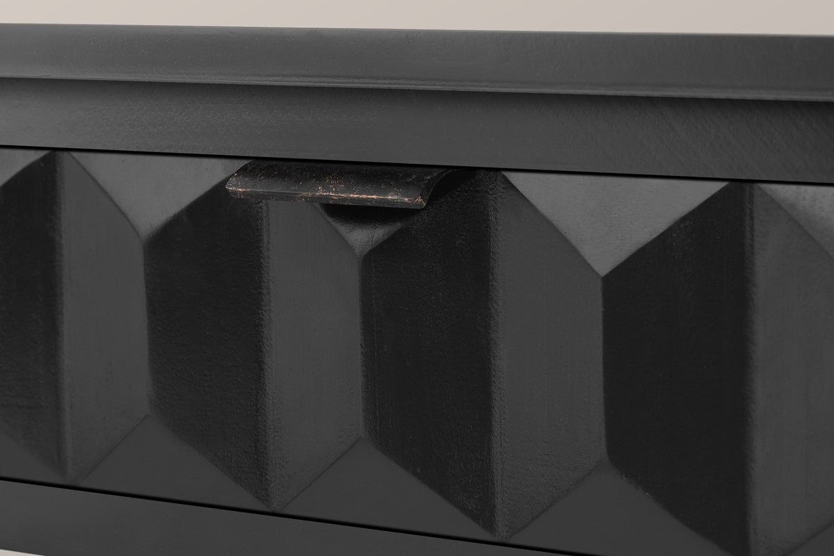 Close-up of a black-painted honeycomb drawer front with its distressed iron lip pull on the top edge