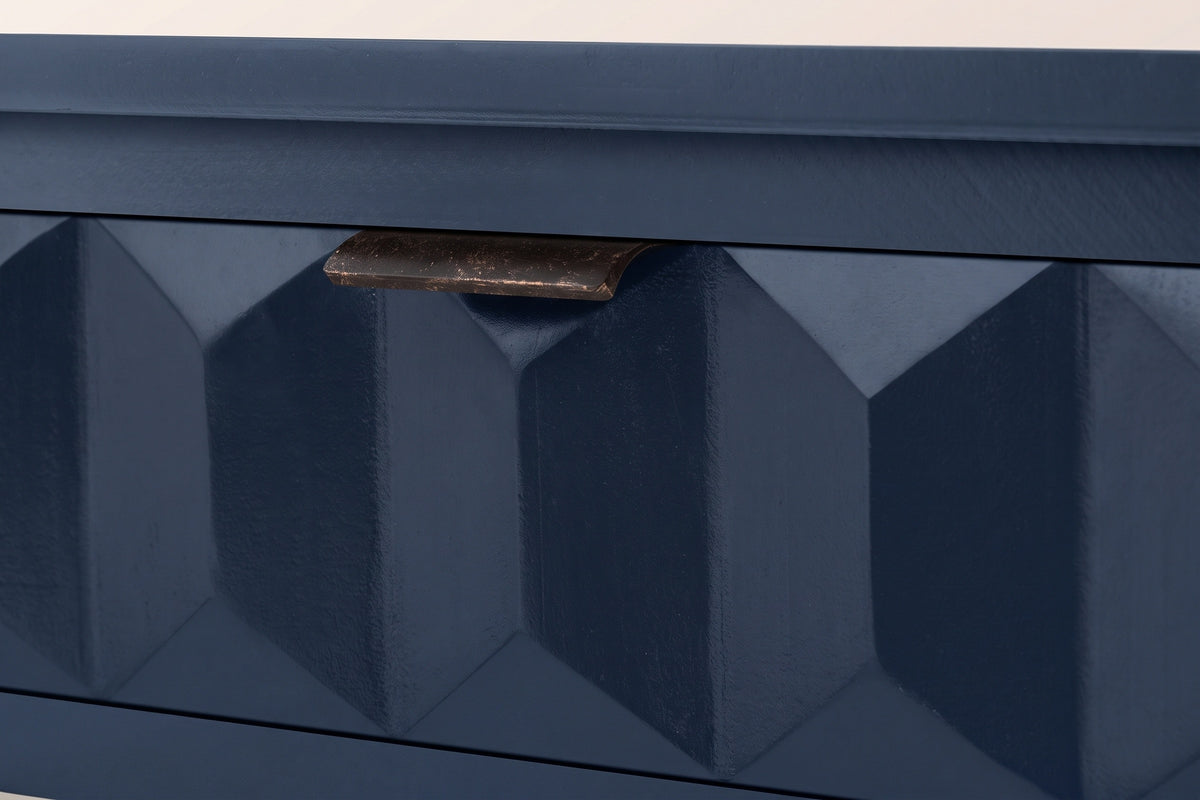 Close-up of a navy blue painted honeycomb drawer front with its distressed iron lip pull on the top edge