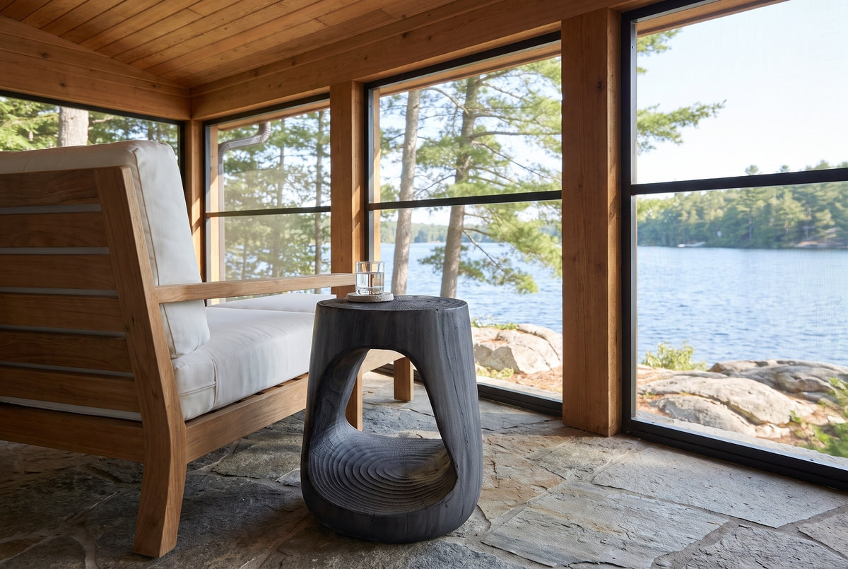 Venzone side table in Black beside a teak lounge chair on a screened Muskoka cottage porch above the lake
