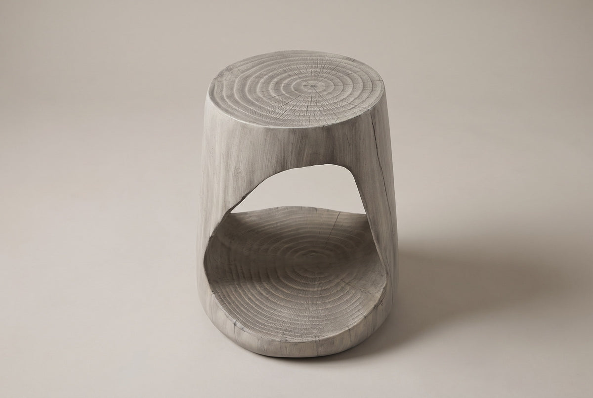 Venzone side table in Grey, front view: a round ring-textured top and one rounded-triangle opening through the drum