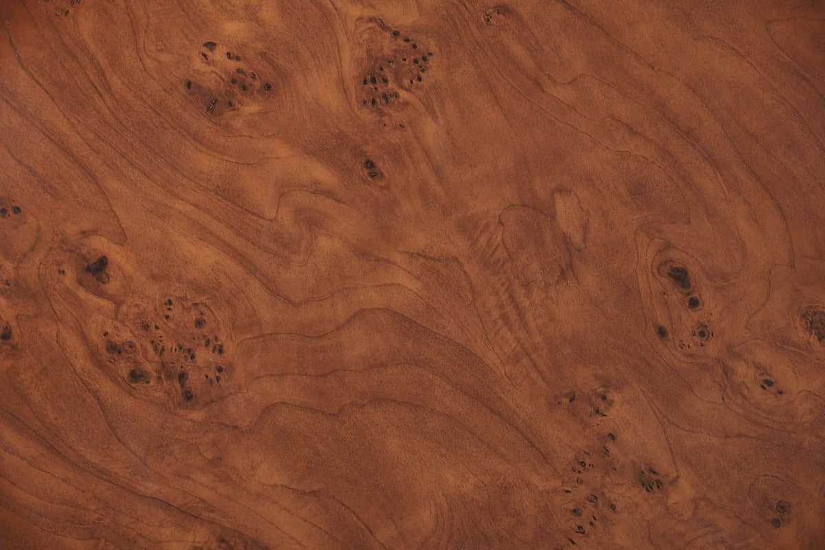 Close-up of the Vieste top: swirling burl figure with clusters of small dark eyes