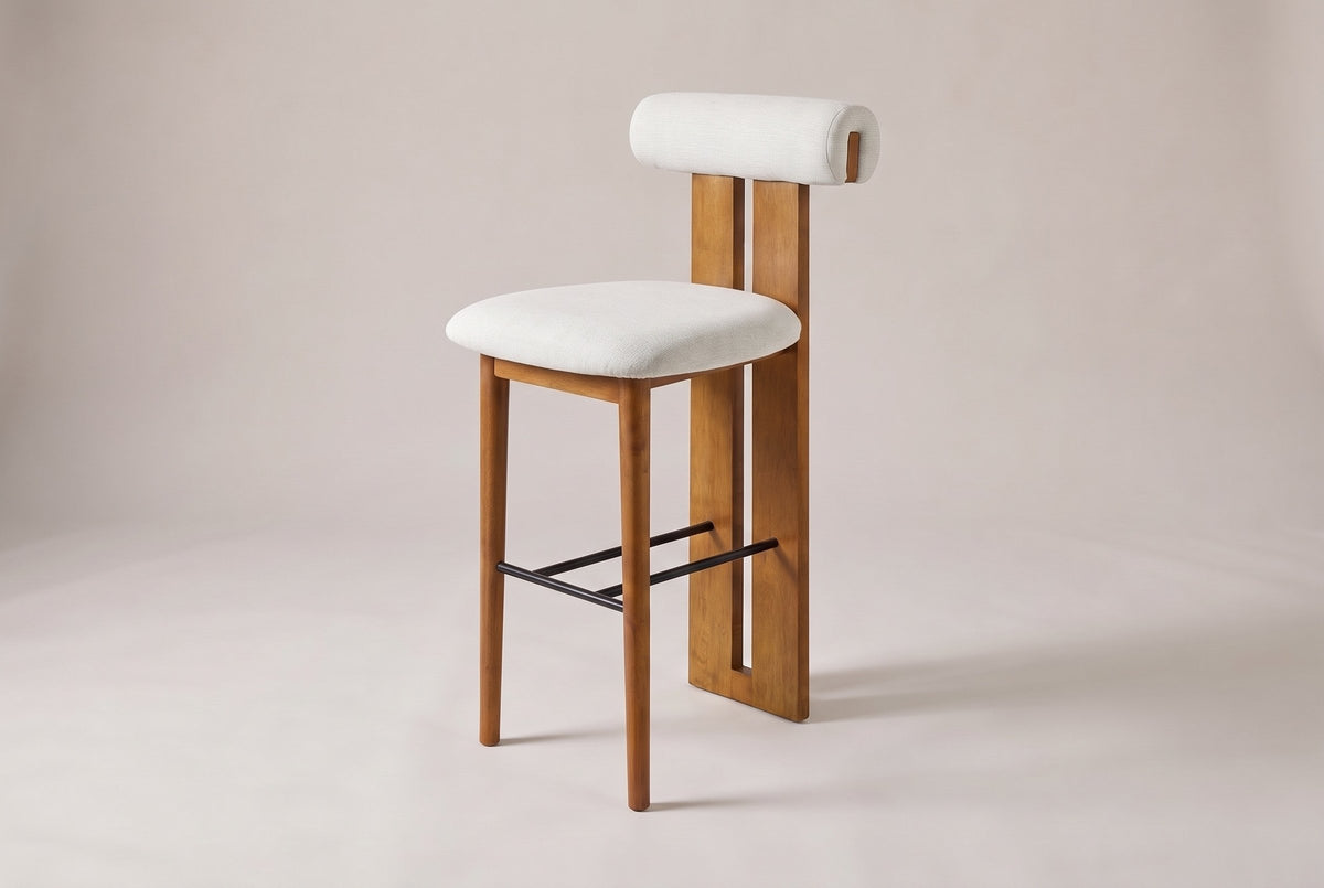 Vigoleno bar stool in Ivory, three-quarter view on a warm grey studio backdrop