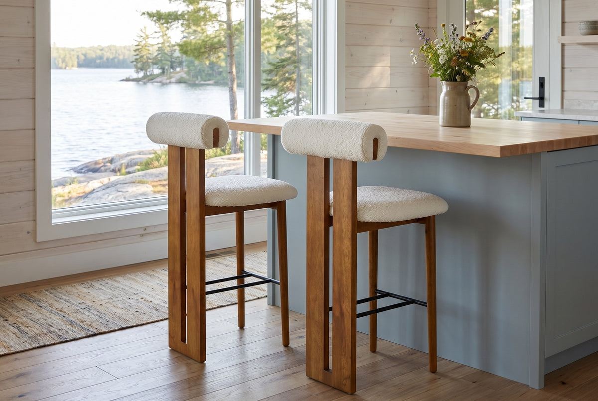 Two Vigoleno bar stools at a butcher-block island in a Muskoka cottage kitchen with a window onto the lake