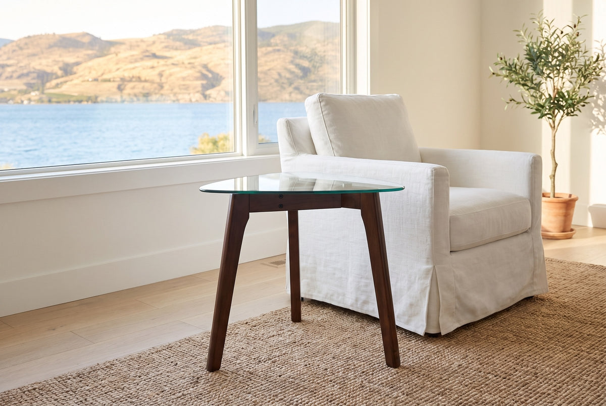 Vipiteno side table beside a white slipcovered armchair in a Kelowna lake house, the lake and hills through the window