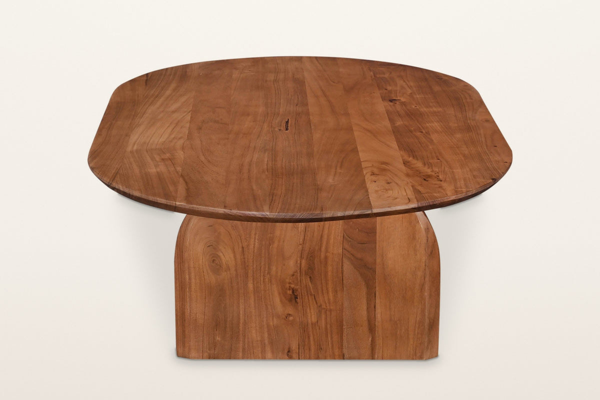 Visso coffee table in Pecan from the end on a warm white studio backdrop: an arched panel under the oval top
