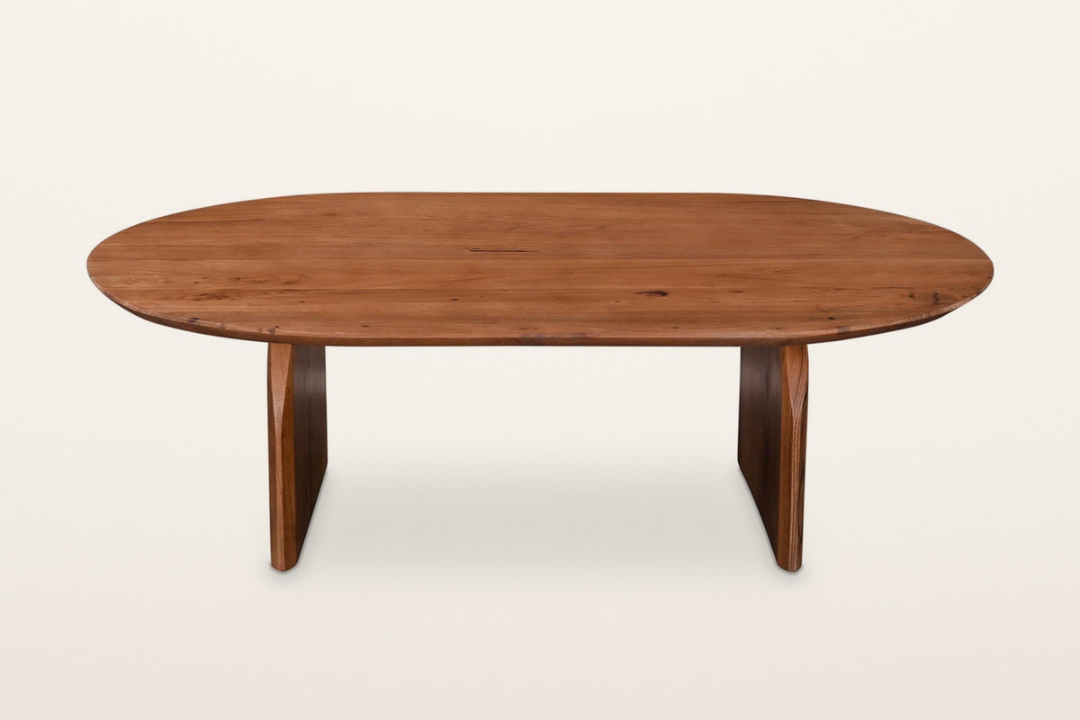 Visso coffee table in Pecan from the front on a warm white studio backdrop: both panel legs set in from the ends