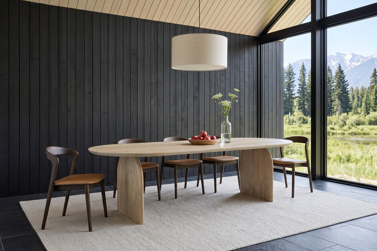 Visso dining table in Natural in a timber house in Golden, BC: charcoal board wall, glass to the Purcell Mountains