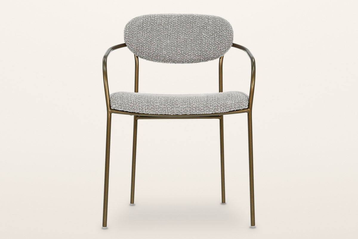 Vitorchiano arm dining chair from the front: the oval back pad, both bronze arms bending back to the hoop behind it, the seat pad and four straight legs