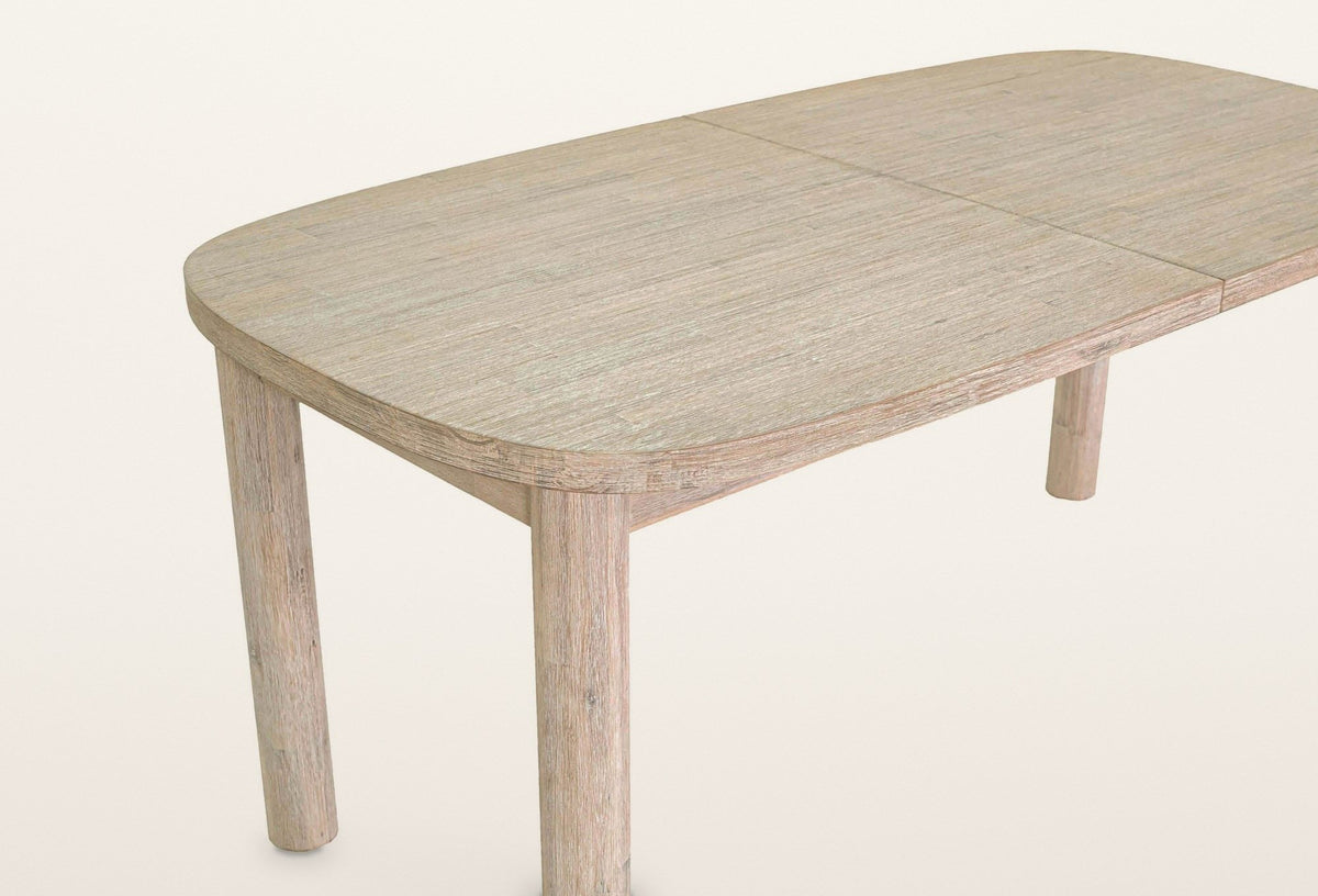 Close-up of one Vitorchiano corner: the softly rounded corner of the top, the round leg and the seam where the table opens