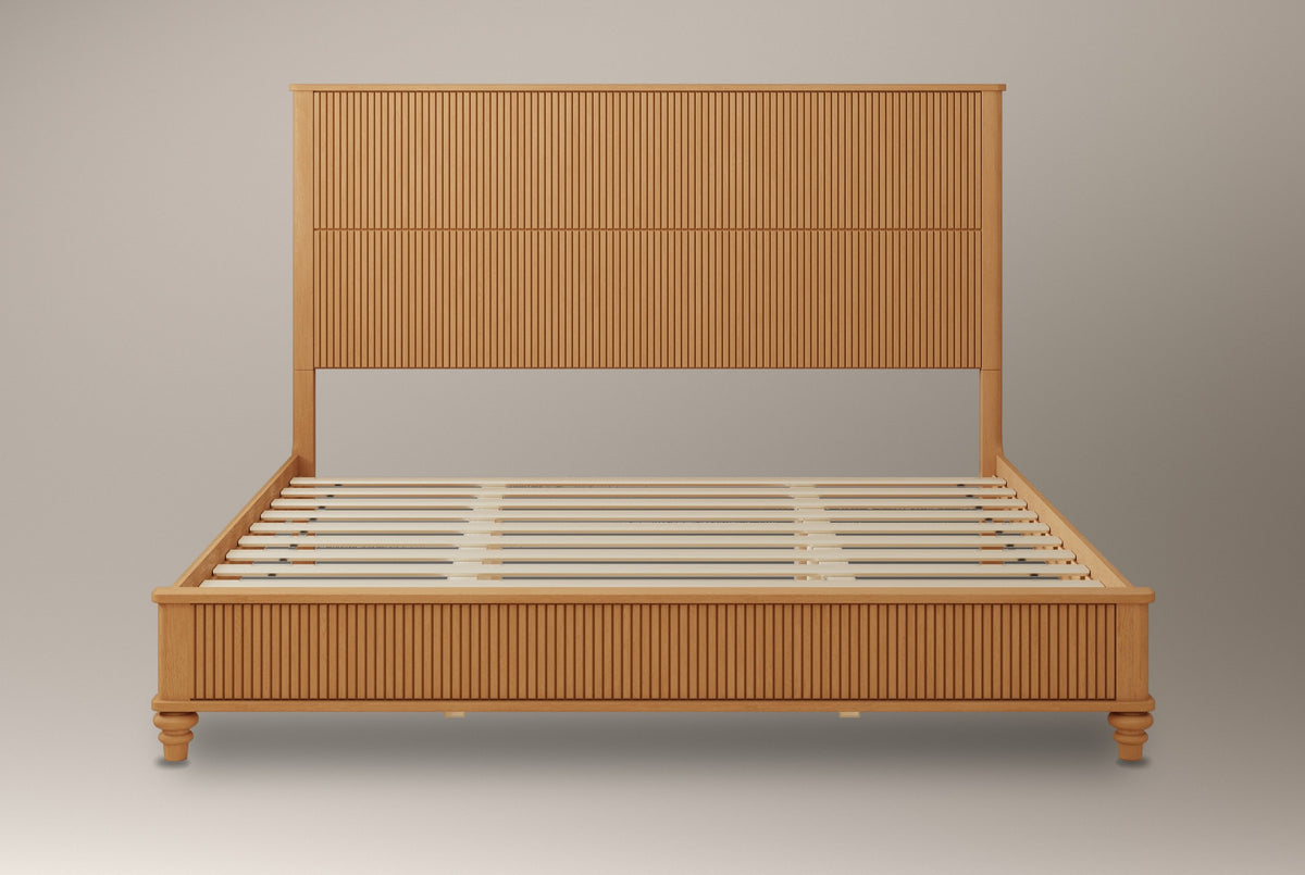 Volterra reeded bed in natural, straight front view of the bare frame and slats on a studio backdrop