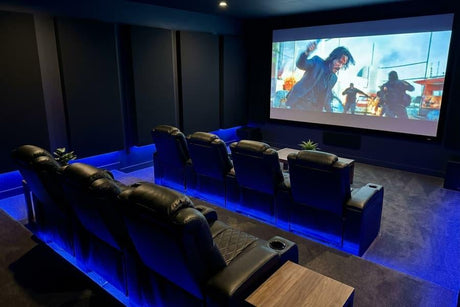 Modern home theater room with two rows of Valencia leather recliners facing a large projection screen