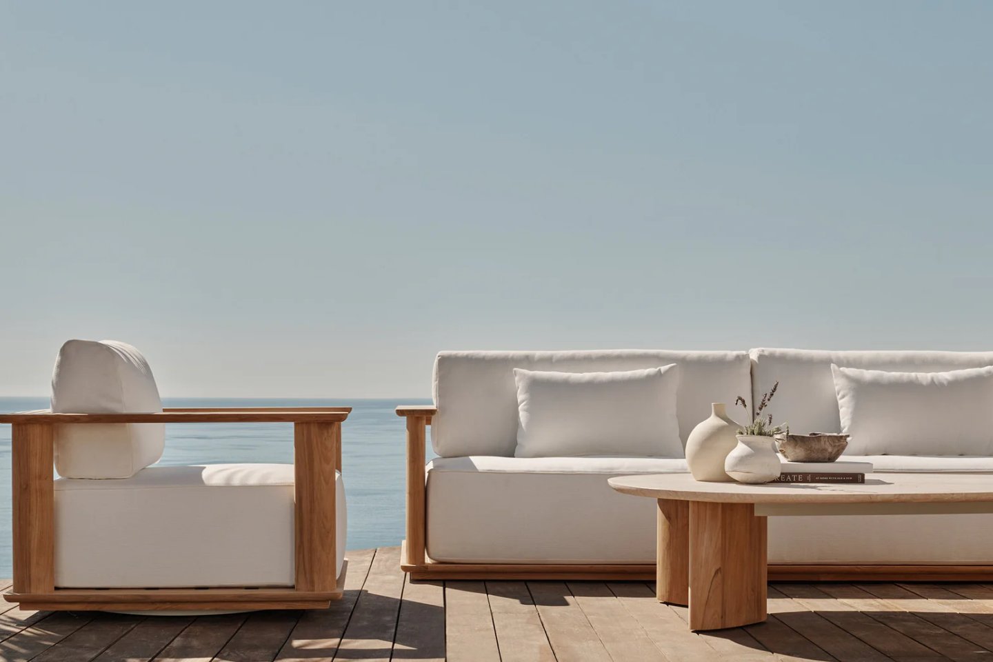 Relax outdoors in style with this stunning teak outdoor furniture set. Featuring plush white cushions and a sleek design, it’s perfect for patios or seaside lounging.