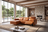 Andria cognac leather sectional in a modern living room with a stone fireplace and pool view