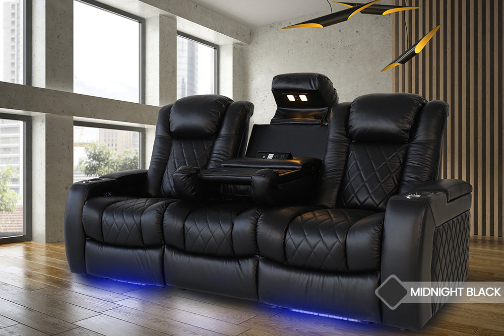 In a Living Room, There is Left Angled Front View of A Luxurious, Midnight Black, Wood and Steel Frame, Tuscany Premium Top Grain Nappa Leather Console Edition Home Theater Seating.