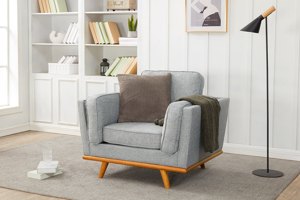 Right Angled Front View of A Modern, Grey, Single, Fabric Artisan Sofa in a Living Room.