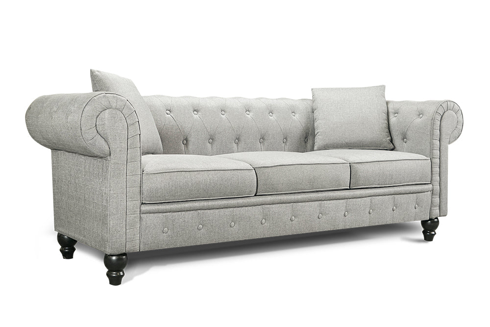 Left Angled Front View of A Classic, Light Grey, Three Seats, Cerna Chesterfield Fabric Sofa.