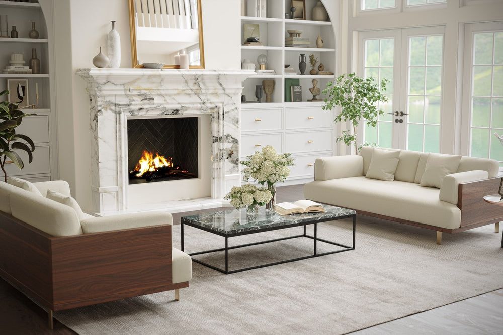 In a Living Room With A Mini Table with Flowers in Front of a Fireplace, There is Right Acute Angle Front View of A Luxurious, Beige, Kiln Dried Wood Frame, Emilia Modern Fabric Sofa