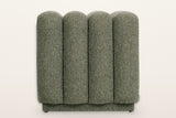 Abbadia ottoman in moss, straight view of the rounded ends of its four channels above the recessed plinth