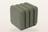 Abbadia channel-tufted square ottoman in moss, three-quarter view on a warm white studio backdrop