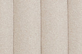 Close-up of the Abbadia channels in oat: deep grooves between rounded rolls of flecked cream fabric