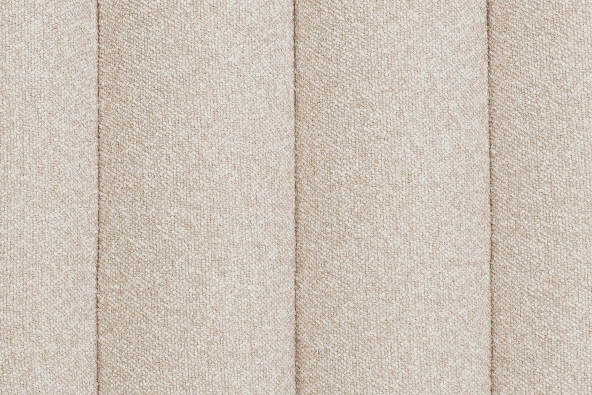 Close-up of the Abbadia channels in oat: deep grooves between rounded rolls of flecked cream fabric