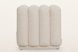 Abbadia ottoman in oat, straight view of the rounded ends of its four channels above the recessed plinth