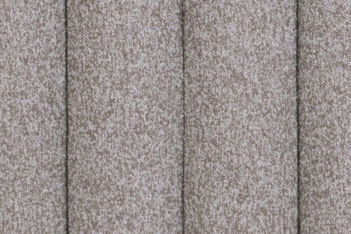 Close-up of the Abbadia channels in stone: deep grooves between rounded rolls of flecked warm grey fabric