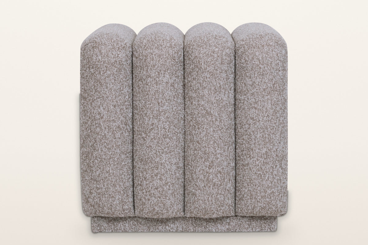 Abbadia ottoman in stone, straight view of the rounded ends of its four channels above the recessed plinth