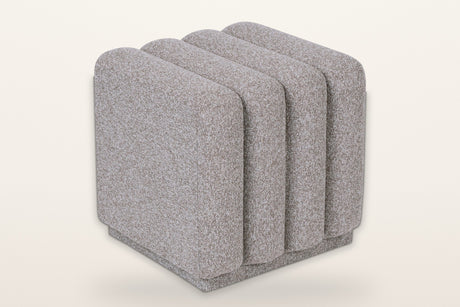 Abbadia channel-tufted square ottoman in stone, three-quarter view on a warm white studio backdrop